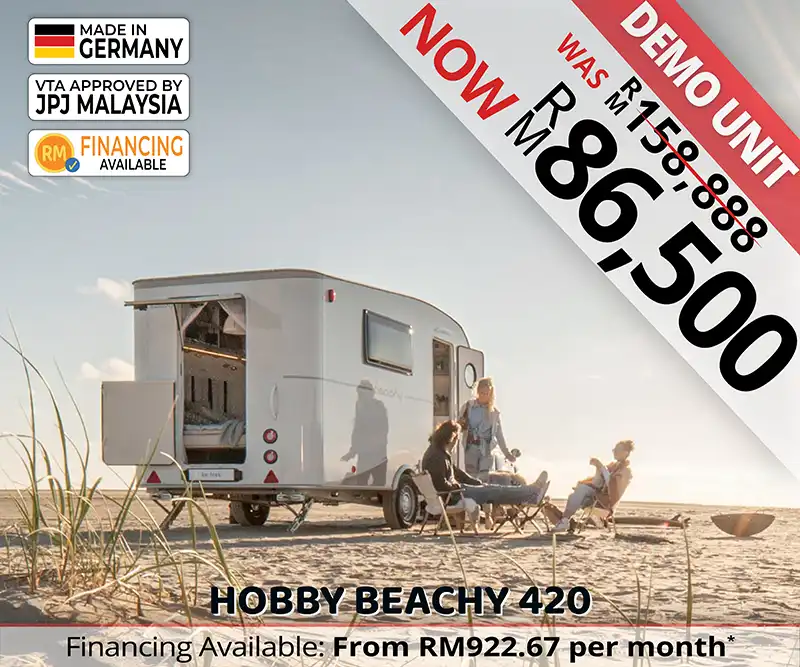 Group of friends sitting outside Hobby Beachy 420 caravan enjoying outdoor leisure at a Malaysian beach.