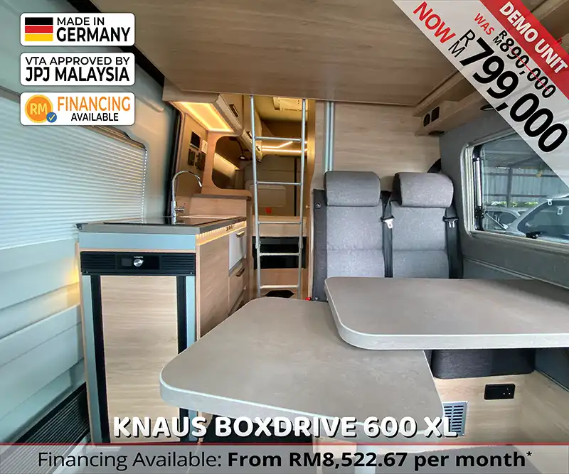 Interior view of the Knaus Boxdrive 600 XL from the driver’s cabin, highlighting the open-plan living area and luxury finishes for Malaysian travel.