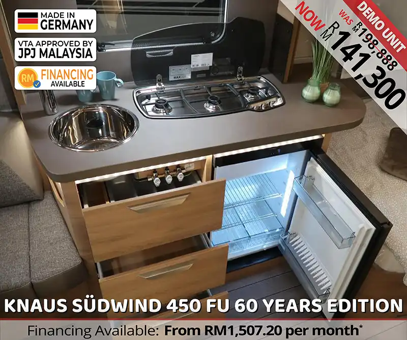 Kitchen of Knaus Südwind 450 FU 60 Years Edition caravan with stove, sink, and fridge for travel in Malaysia.