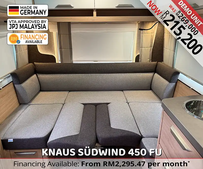 The dining area features soft seating and a foldable table that converts into an extra sleeping space, perfect for couples or small families.