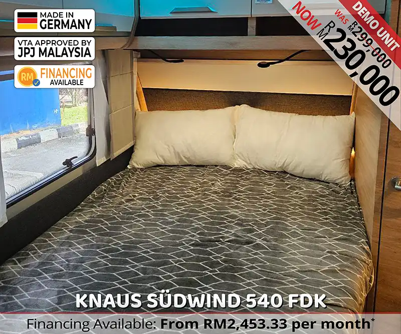 Knaus Südwind 540 FDK double bed with soft lighting and privacy divider for restful nights in Malaysia.